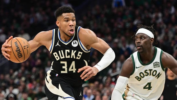 Milwaukee Bucks star Giannis Antetotkounmpo drives against Boston Celtics guard Jrue Holiday